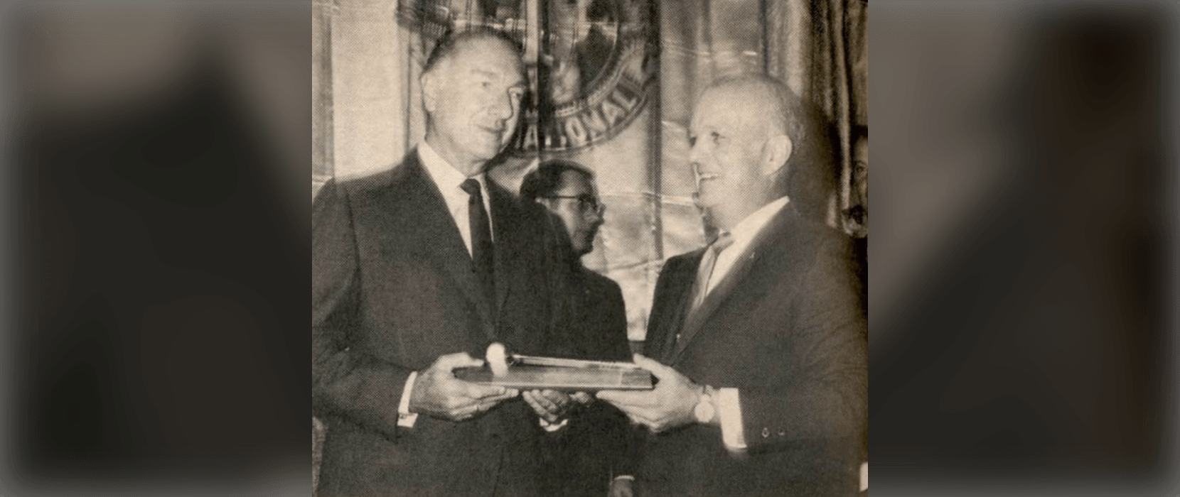 Two men holding award