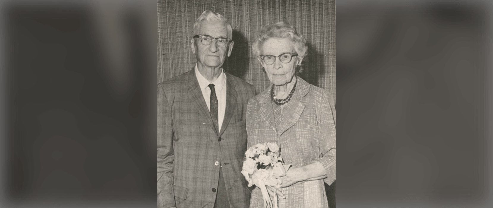 Black and white photo of a man and woman both wearing glasses