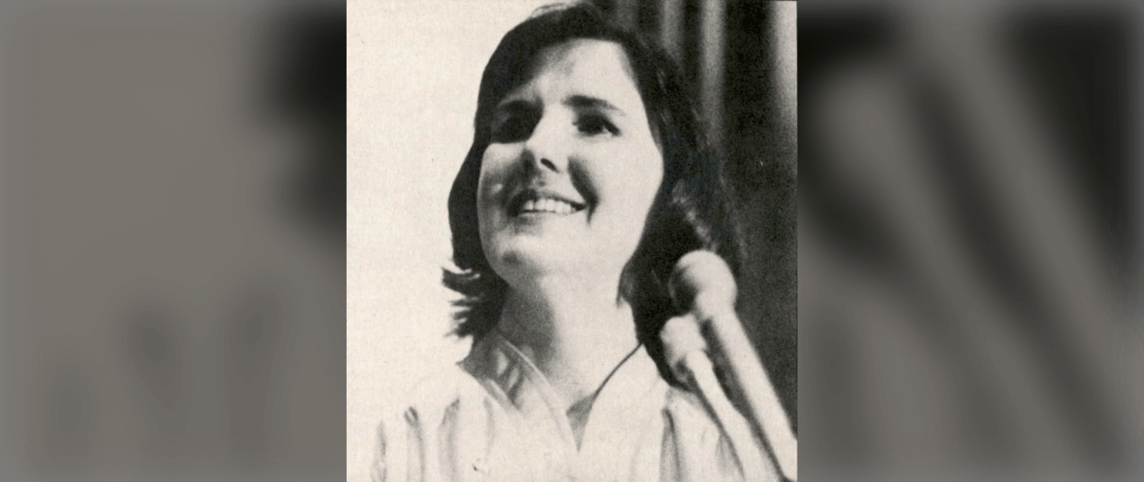 Black and white photo of a woman smiling