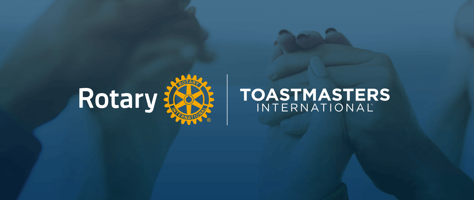 Rotary and Toastmasters International’s logos with blue background and hands holding in the air