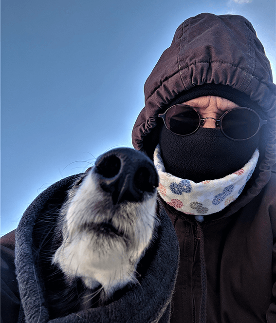 Woman and dog in winter jackets