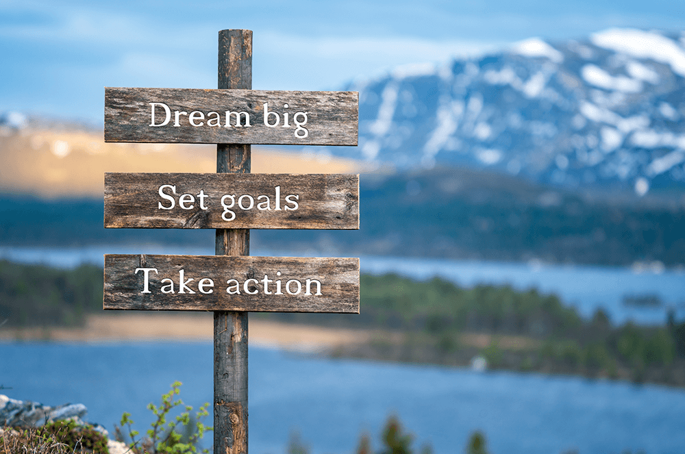 Sign with words dream big, set goals, take action