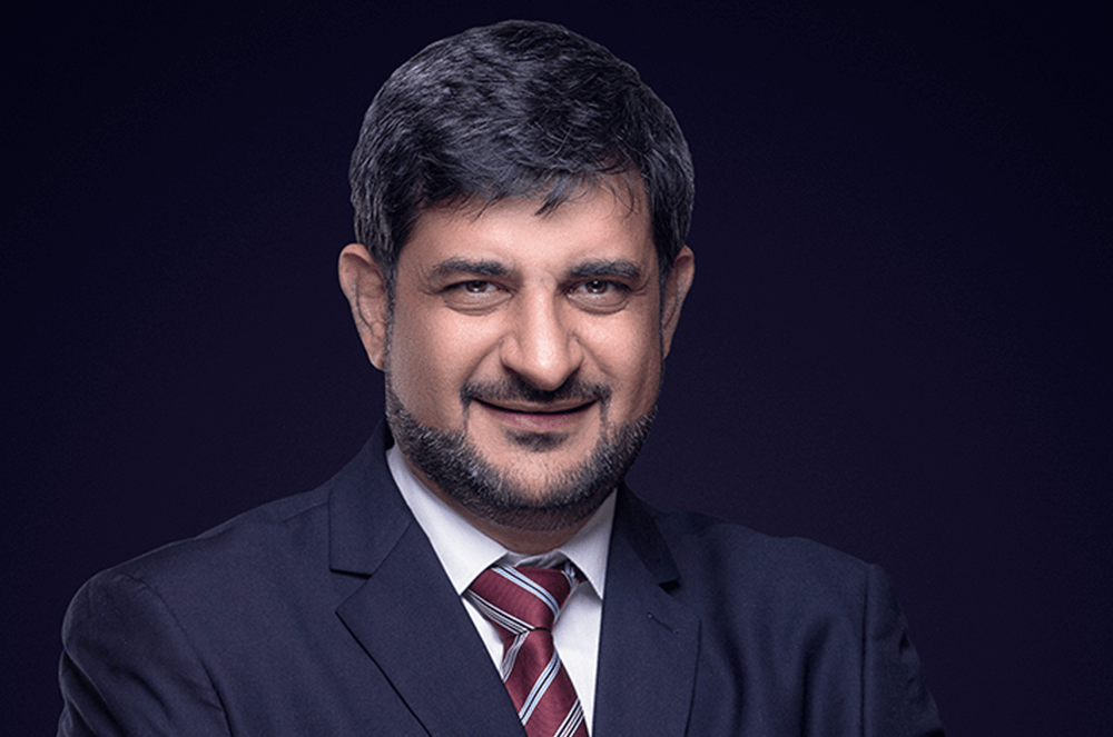 Mohamed Ali Shukri in suit jacket and tie