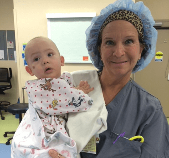 Nurse holding baby at hospital