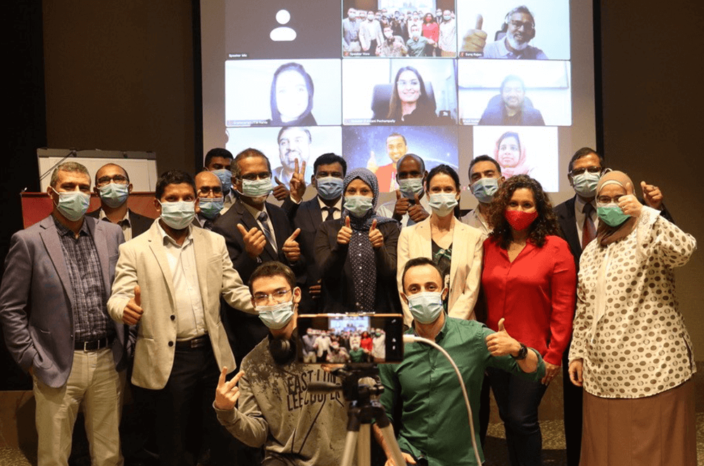 Group of people wearing masks during meeting