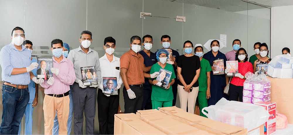 Group posing in masks holding magazines