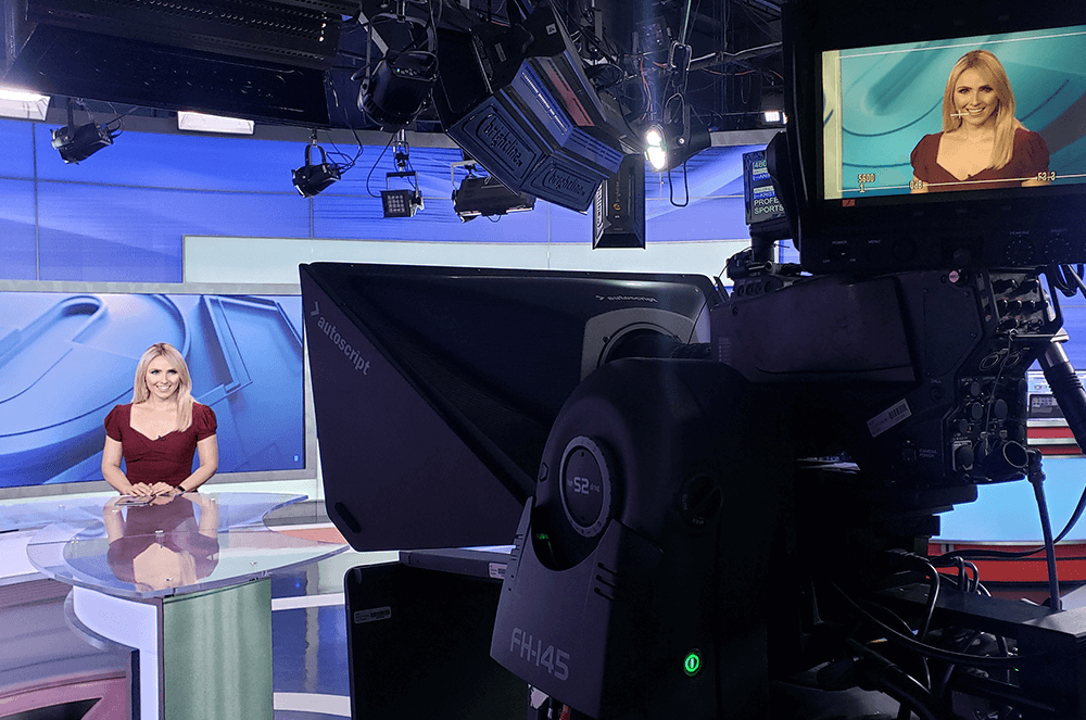 Woman filming at news desk