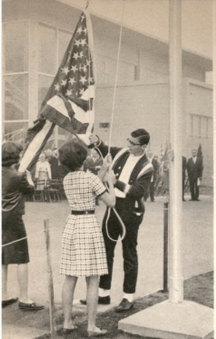Students raising American flag