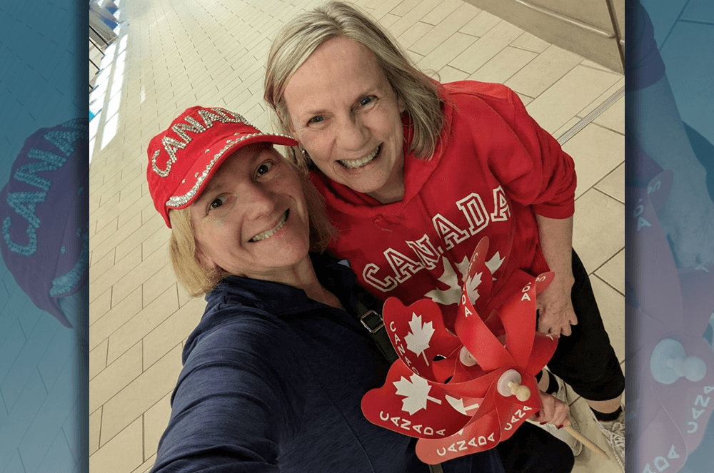 Two women dressed in red Canadian outfits