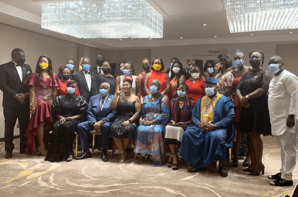 Large group of people in formal wear with medical masks at induction ceremony