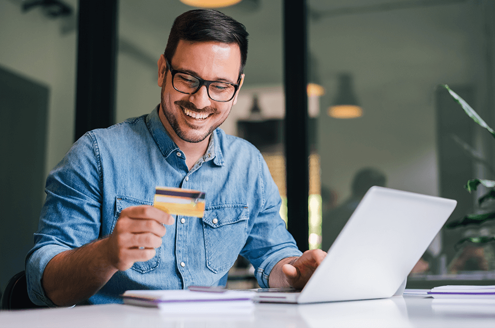 Man holding credit card and smiling