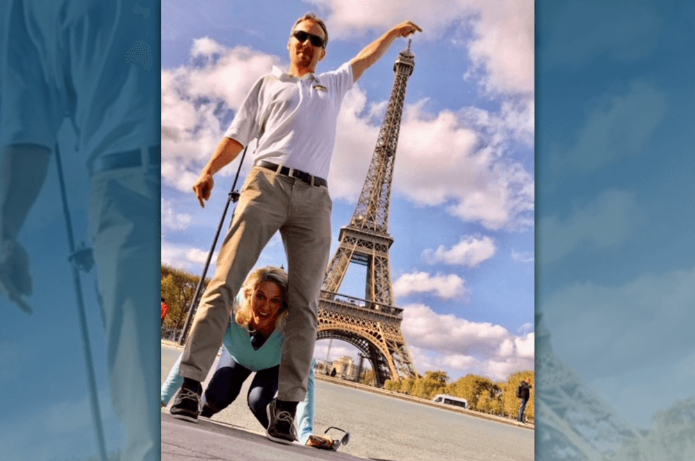 Man and woman posing funny with Eiffel Tower in Paris