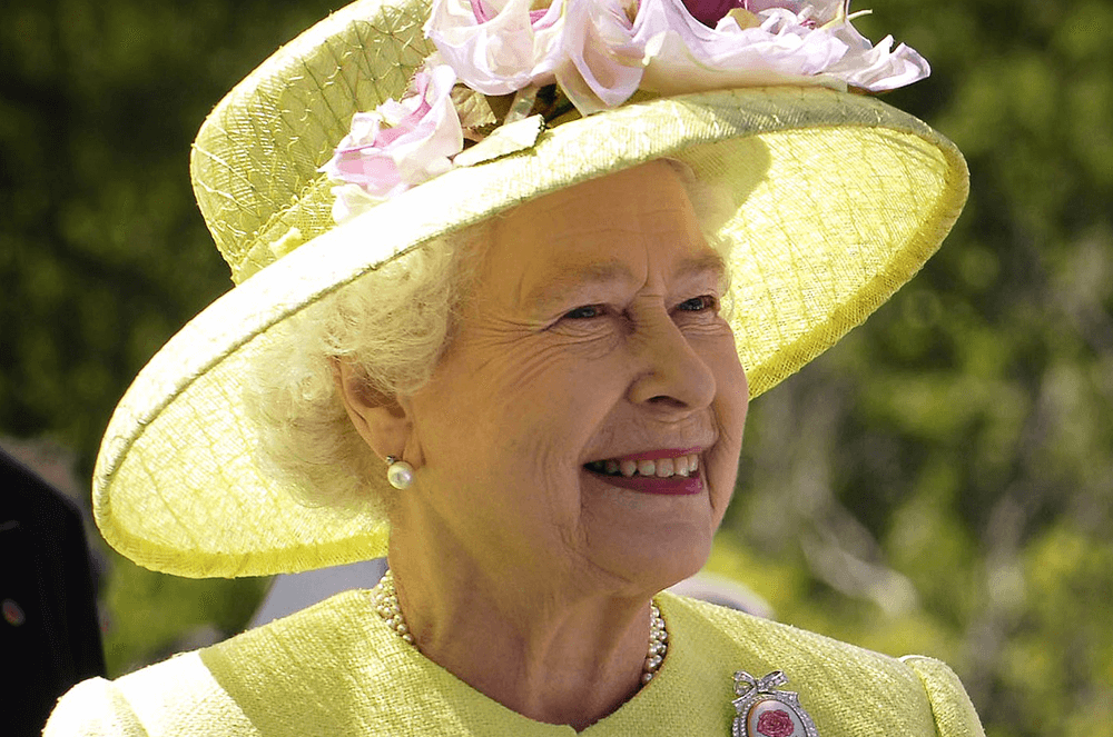 Queen Elizabeth II in green dress and hat with flowers